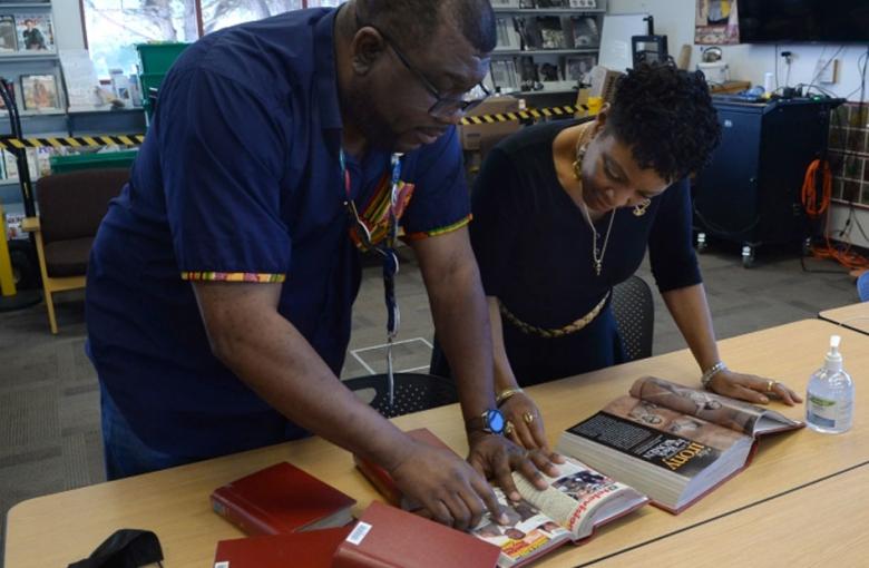 Etienne and Oshalla looking through old magazines.