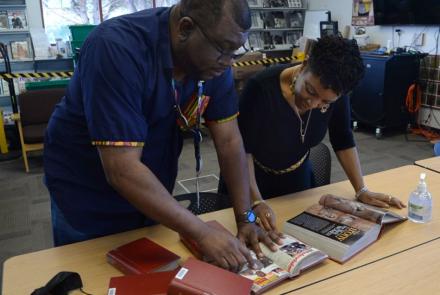 Etienne and Oshalla looking through old magazines.